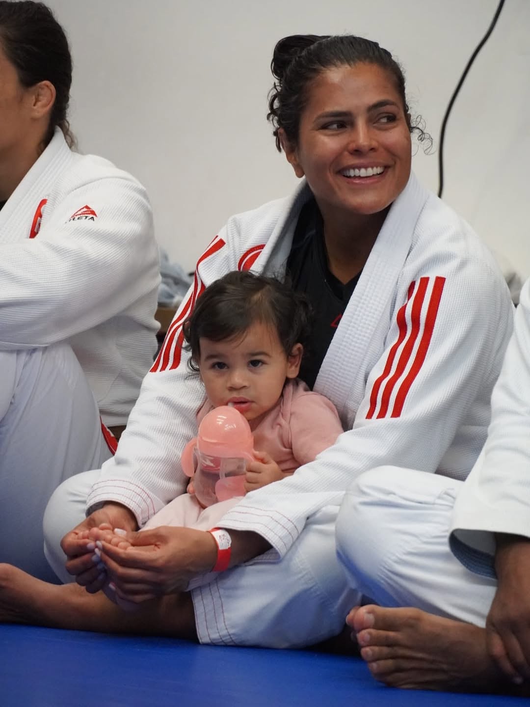 Family-friendly community at Gracie Barra Boca Raton — a mother in gi with her child on the mat